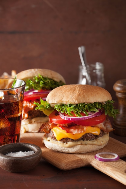 Hamburguesa de tocino y queso con empanada de carne, tomate y cebolla