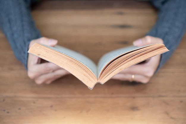 Foto hand, die zu hause ein buch hält