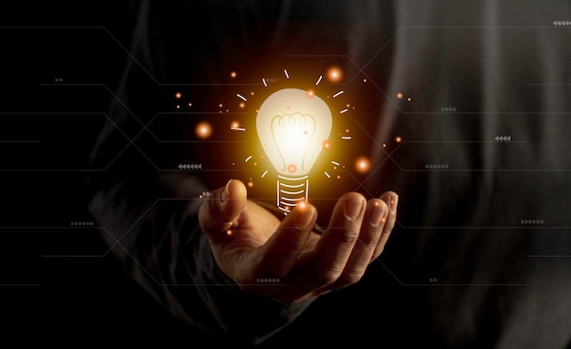 Hand hält Glühbirnen-Ideenkonzept mit Innovation und Inspiration Glühbirnen-Lichtzeichnungsidee in der Hand