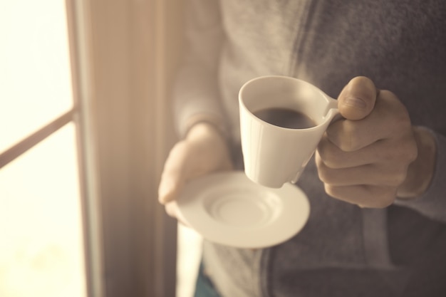 Hand holding coffee cup