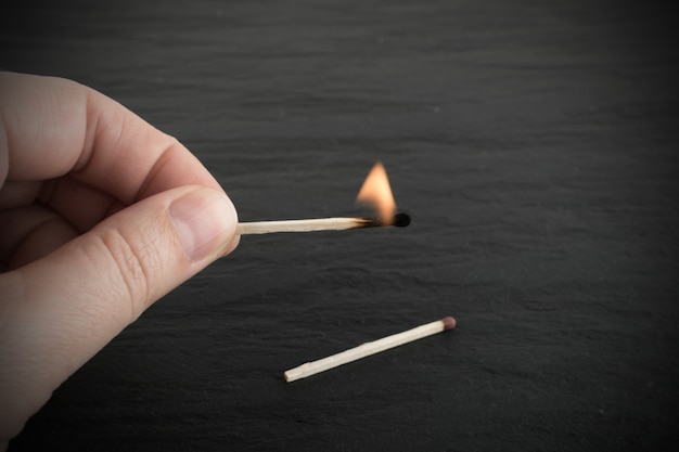 Hand Рolding Burning Match