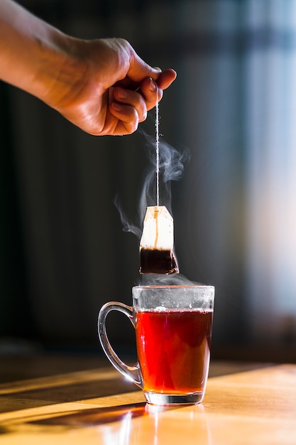 Foto handbrühende tasse schwarzer tee