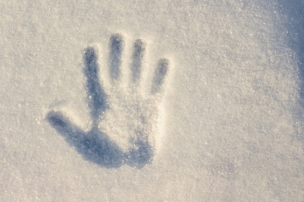 Handprint en blanco con un tono azul de nieve con un día soleado de invierno