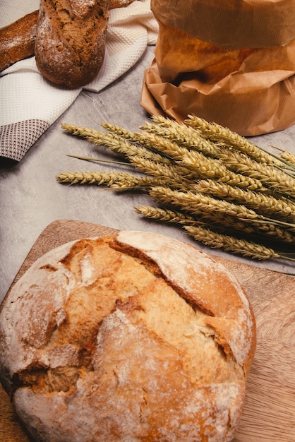 Handwerkliches Brot mit Weizengetreide auf einem Steintisch