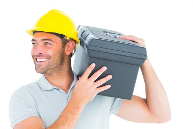 Handyman que transporta a caixa de ferramentas no ombro
