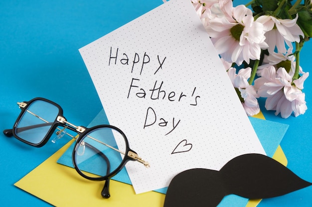 Happy Father's Day Concept Notepad Postkarte und Konyert Happy Father's Day Schriftzug auf Papier und Blumen