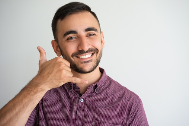 Happy Handsome Man Making Call Me Gesture