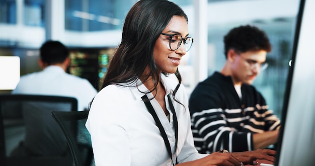Happy woman and developer on computer in office for programming software update and troubleshooting Female person pc and coding app with website development testing server and system application