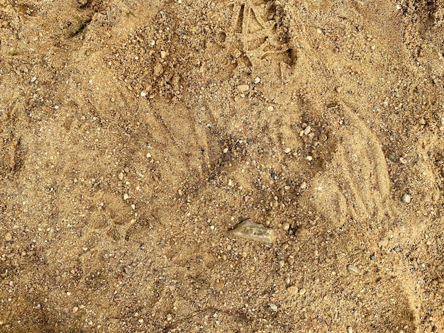 Haufen von gelber Sandstruktur Baumaterialien Sandhaufen mit kleinen Steinen