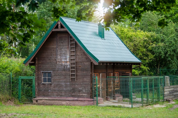 Haus im Wald Haus im Wald mit einem grünen Dach und einem Zaun von wilden Tieren