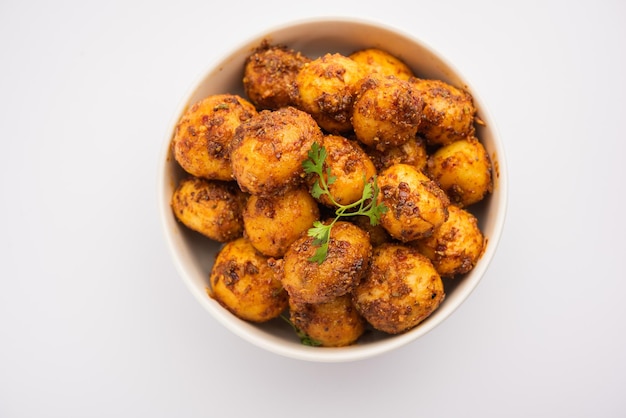 Hausgemachte geröstete Bombay-Kartoffeln In der Pfanne gebratene kleine Babykartoffeln oder Aloo mit Jeera-Samen und Koriander in einer Schüssel