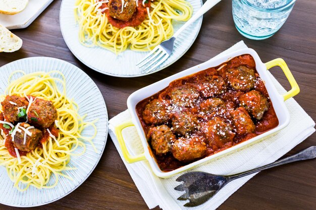 Hausgemachte italienische Fleischbällchen garniert mit Koriander und Parmesan über Spaghetti zum Abendessen.