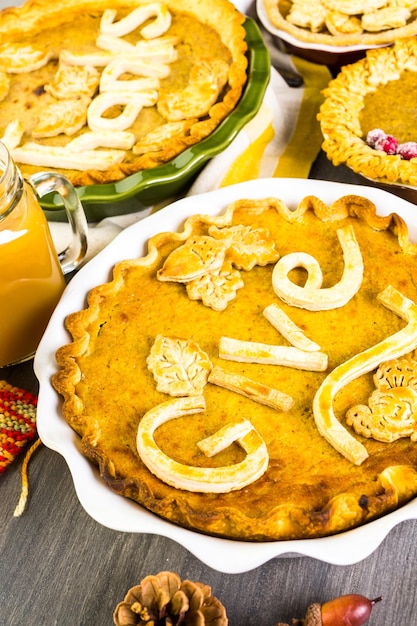 Hausgemachte Kürbiskuchen mit gestempelten Blättern im Herbst.