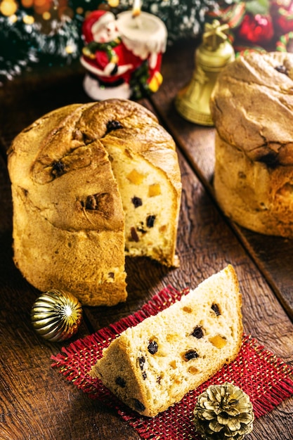 Hausgemachte Panettones auf einem Holztischkuchen oder gebackenes Brot, typisch für brasilianische und europäische Weihnachten