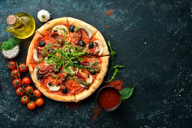 Hausgemachte Pizza mit sonnengetrockneten Tomaten, Pilzen und Oliven italienische Küche Essenslieferung