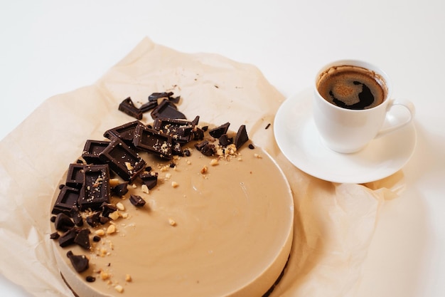 Hausgemachter Schokoladenkuchen auf Pergamentpapier Lieferung von Lebensmitteln Hausgemachtes Backen Draufsicht Leckere Torte mit Schokolade auf dem weißen Tisch