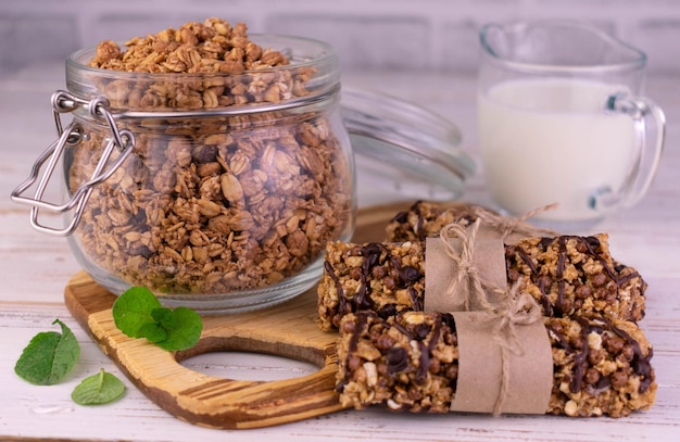 Hausgemachtes Müsli im Glas und Müsliriegel mit Milch