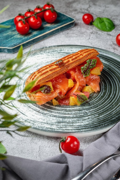 Hausgemachtes Thunfischsandwich in Croissant mit Salat, Ananas auf einem grauen Steintisch. Speisekarte