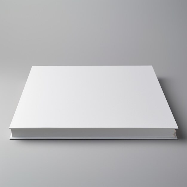 hay un libro blanco con una portada en blanco en una superficie gris generativa ai