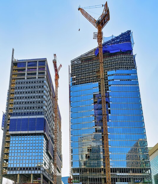 Hebekräne und Wolkenkratzer im Stadtteil Jongno in Seoul, Südkorea