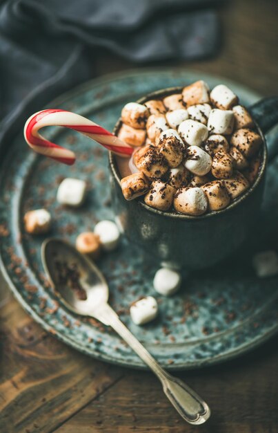 Heiße Weihnachtsschokolade mit Marshmallows, Kakao und Zuckerstange