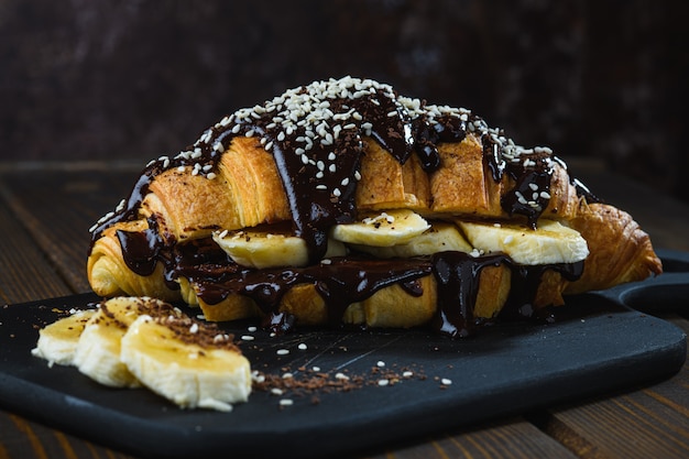 Heißer Kaffee und Schokoladencroissant mit Banane