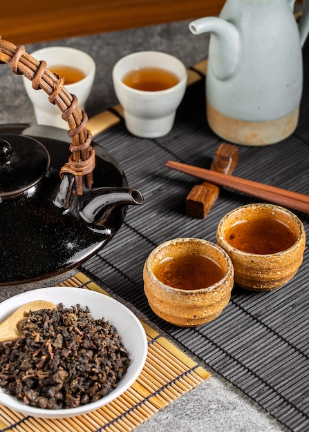 Heißer Tee in Glasteekanne und Tasse mit Dampf