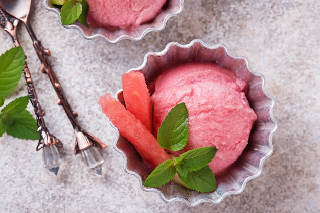 Helado de sandía en cuencos de metal.