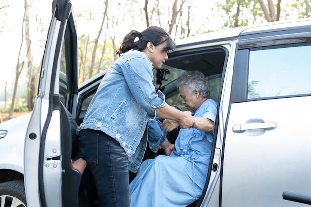 Helfen und unterstützen Sie asiatische Senioren oder ältere Frauen, die zu ihrem Auto kommen