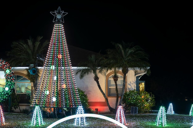 Hell erleuchtete Weihnachtsdekorationen im Vorgarten des Familienhauses in Florida Außendekoration für den Winterurlaub
