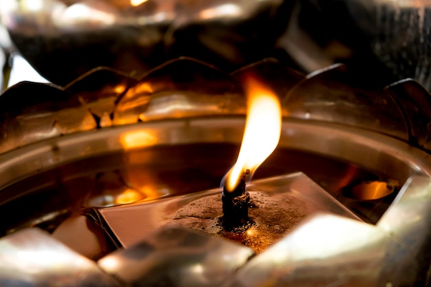 helle Kerze in der Öllaterne am buddhistischen Tempel in Thailand
