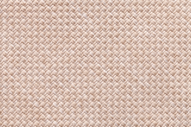 Heller beige Hintergrund des dichten gesponnenen Absackgewebes, Nahaufnahme. Struktur des Textilmakros.