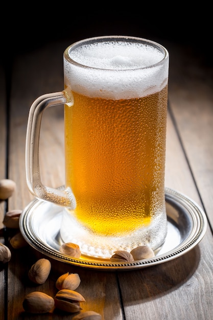 Helles Bier in einem Bierglas auf einem alten Hintergrund.