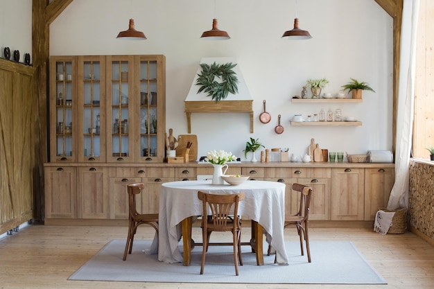 Helles Kücheninterieur aus Holz mit Tisch in der Mitte des Esszimmers Schöne Innenarchitektur der Küche