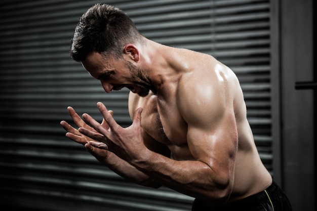 Hemdloser Mann, der an der crossfit Turnhalle schreit