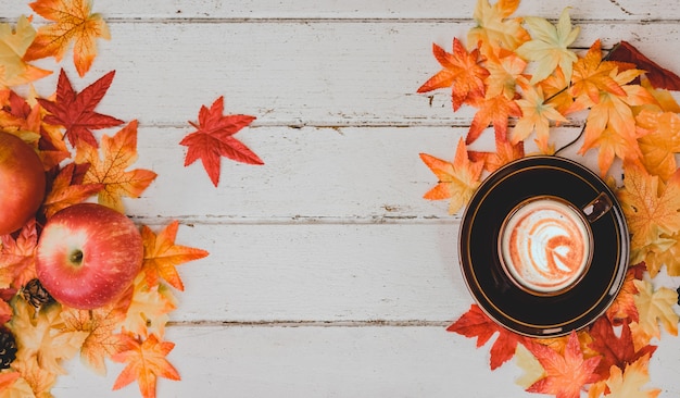 Herbst- und Herbstsaison. Heißer Kaffee mit gefälschtem Ahornblatt auf Holztisch. Ernte Füllhorn und Thanksgiving Day Konzept.