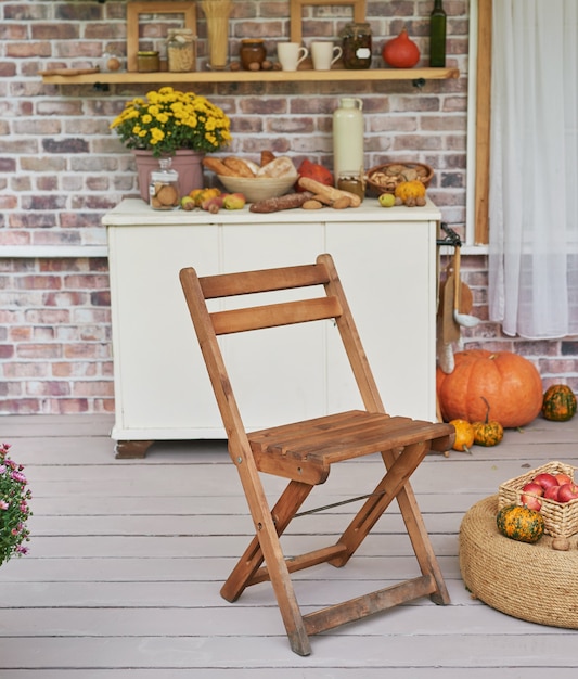 Herbsternteterrassenhintergrund. Halloween. Land. Kürbisse und Blumen. Ferienhaus. Erntedankfest