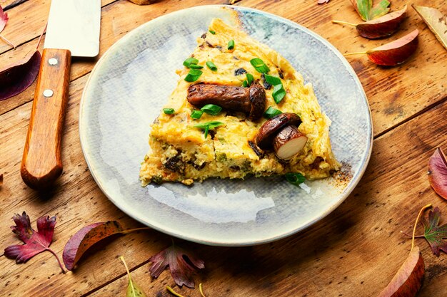 Herbstkuchen mit Waldpilzen. Stück vom offenen Pilzkuchen