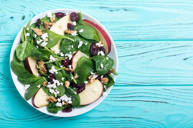 Herbstlicher Spinatsalat mit Apfelkäse, Walnuss und getrockneten Preiselbeeren. Gesundes vegetarisches Essen