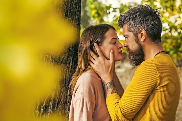 Herbstpaar in der Liebe des glücklichen Mannes und der Frau küssen mit gelben Baumblättern im Park im Freien, Liebe und Beziehungen.