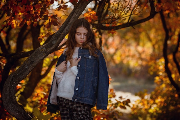 Herbstporträt eines glücklichen, schönen und schönen kaukasischen Mädchens im Wald in Herbstfarben Konzept der Herbststimmung