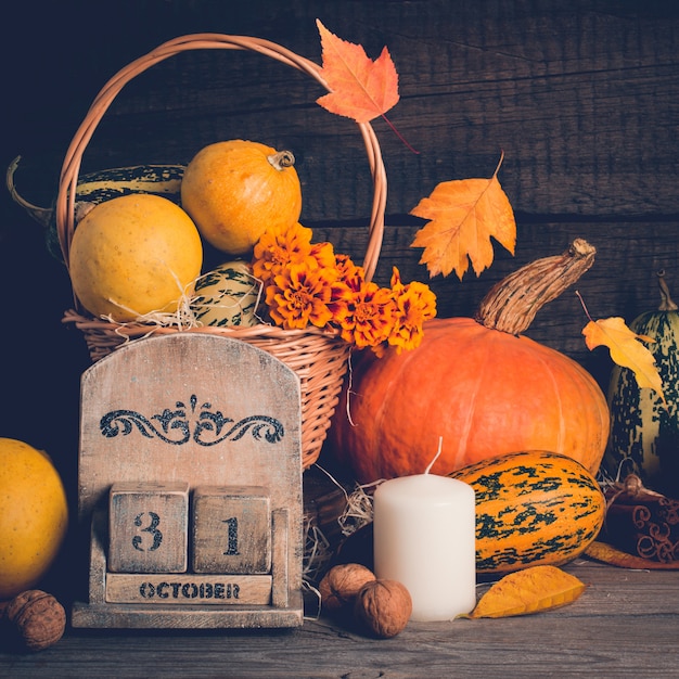 Herbststillleben mit Kürbisen und fallenden Blättern