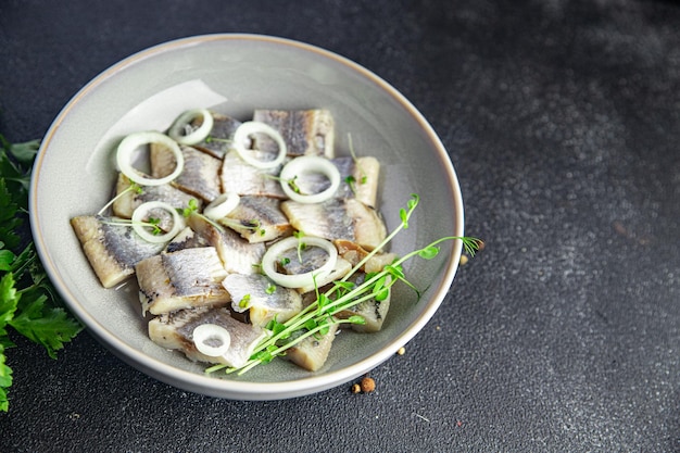 Heringsscheibe Fischstücke mit Zwiebeln Meeresfrüchte gesunde Mahlzeit Snack auf dem Tisch Essen