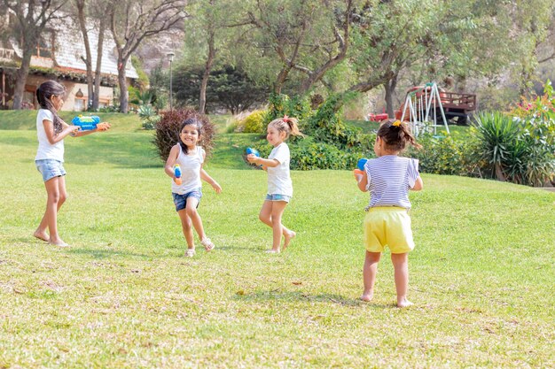 Foto hermanos jugando en el césped.