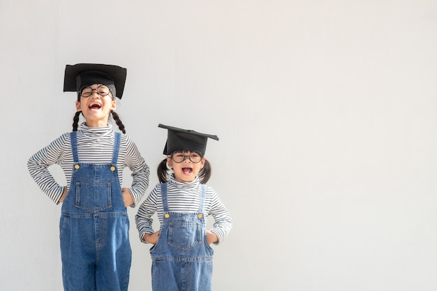 Hermanos niños niña graduación con gorra