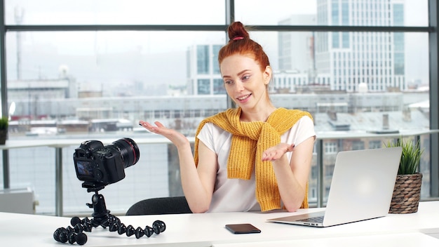 Hermosa bloguera toma un tutorial de belleza en una cámara de video digital