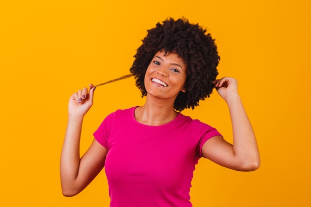 Hermosa chica afroamericana con un peinado afro sonriendo. Mujer con cabello negro