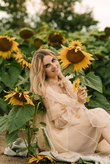 Hermosa chica atractiva en un campo de girasoles