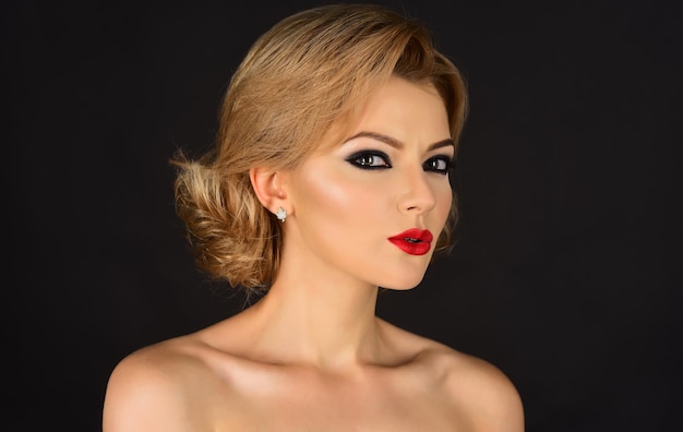 Hermosa chica atractiva con una piel perfecta, labios rojos, maquillaje y cabello rubio. Rostro de mujer hermosa modelo de moda. Retrato con piel perfecta, labios rojos. Sexy mujer rubia con maquillaje de lujo.