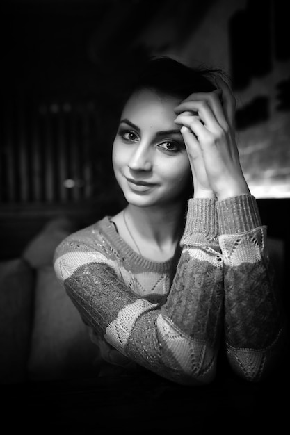 Hermosa chica en un café tomando una taza de café en una cena